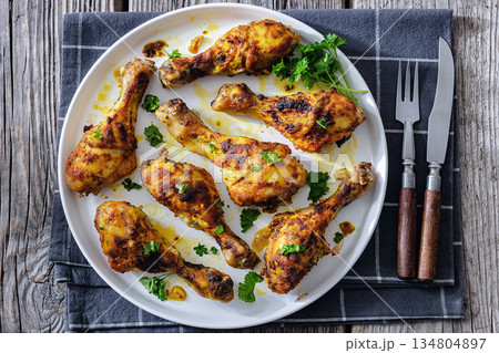 roasted chicken drumsticks on a white plate roasted chicken drumsticks on a white plate 134804897
