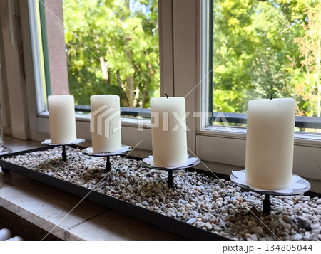 Decorative composition and candles on the windowsill Decorative composition and candles on the windowsill 134805044