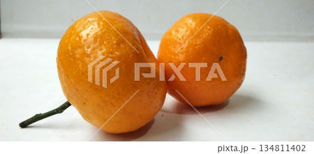 Two bright oranges placed on a clean white background. Two bright oranges placed on a clean white background. 134811402
