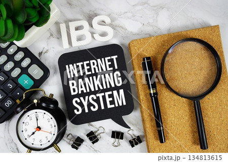 IBS - Internet Banking System acronym with calculator, alarm clock and magnifying glass, Business concept background IBS - Internet Banking System acronym with calculator, alarm clock and magnifying glass, Business concept background 134813615
