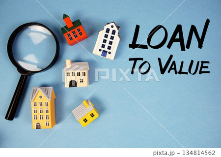 LTV Loan To Value text with house models and magnifying glass on blue background LTV Loan To Value text with house models and magnifying glass on blue background 134814562