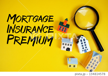 MIP Mortgage Insurance Premium text with house models and magnifying glass on yellow background 134814578
