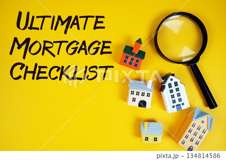Ultimate Mortgage Checklist text with house models and magnifying glass on yellow background 134814586