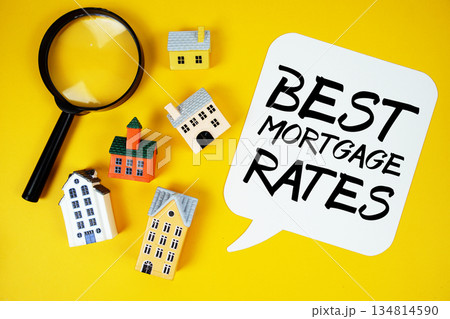 Best Mortgage Rates text with house models and magnifying glass on yellow background 134814590