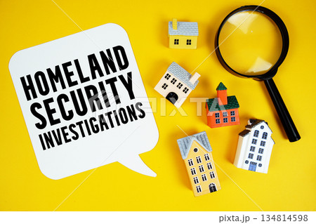 HSI Homeland Security Investigations text with house models and magnifying glass on yellow background HSI Homeland Security Investigations text with house models and magnifying glass on yellow background 134814598