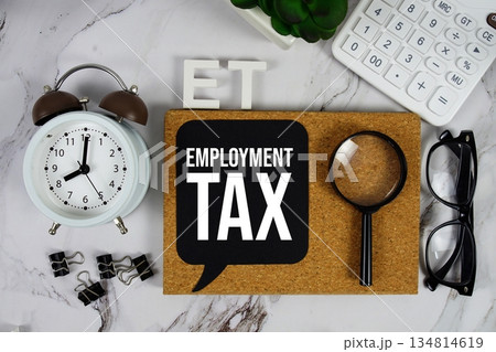 ET - Employment Tax acronym with calculator, alarm clock and magnifying glass, Business and Financial concept background 134814619