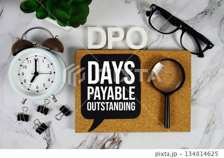 DPO - Days Payable Outstanding acronym with alarm clock and magnifying glass, business concept background 134814625