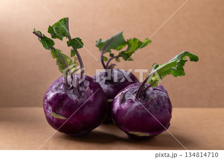 Purple kohlrabi or turnip cabbage on brown background 134814710