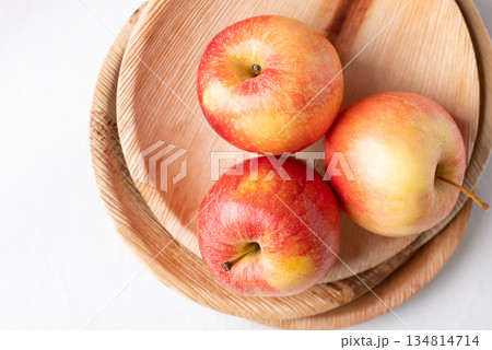 Red apple fruit (Gala apple) in natural plate on white background, Top view 134814714