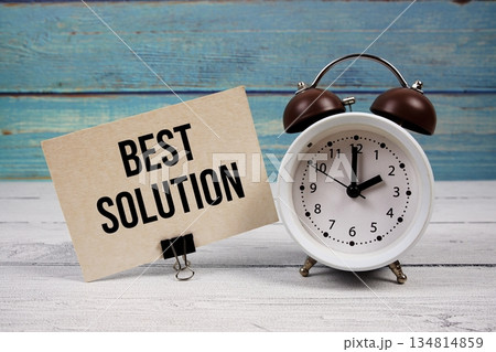 Best Solution text written on paper card with alarm clock on wooden background 134814859