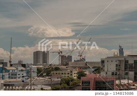 View of Construction of tall buildings with a crane and background of Dramatic sky in the city of Bangkok. View of Construction of tall buildings with a crane and background of Dramatic sky in the city of Bangkok. 134815086