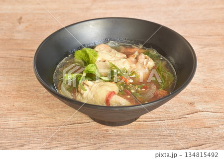 spicy chicken meat with onion and tomato in tom yum soup on bowl spicy chicken meat with onion and tomato in tom yum soup on bowl 134815492