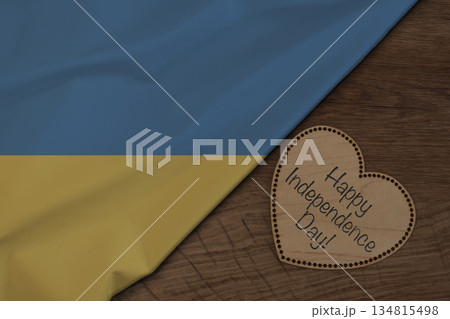 Ukrainian flag and wooden heart with Happy Independence Day text 134815498