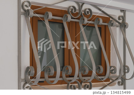 Small window with decorative wrought iron grilles 134815499