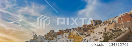 Bright sunny day in Oia, Santorini, Greece, showcasing beautiful white blue cliffside buildings 134815701