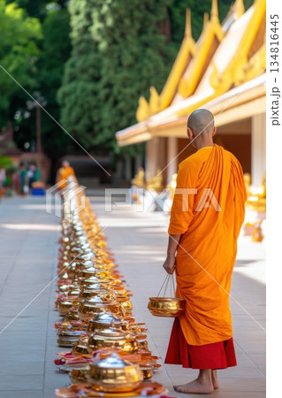 Monk receives alms in a serene temple courtyard surrounded by golden statues and traditional Buddhist decorations during morning rituals Monk receives alms in a serene temple courtyard surrounded by golden statues and traditional Buddhist decorations during morning rituals 134816445