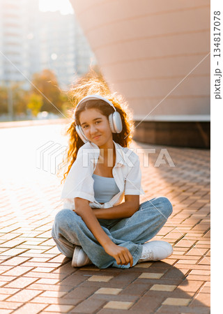 Teen Girl Posing Outdoors In Headphones 134817078