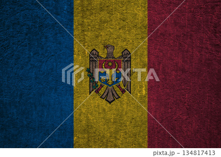 Moldovan flag on a textured uneven wall, patriotic photo Moldovan flag on a textured uneven wall, patriotic photo 134817413