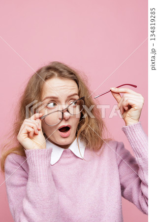 Vertical portrait of surprised woman wearing damaged glasses holding broken arm showing urgent repair warranty claim or replacement concept Vertical portrait of surprised woman wearing damaged glasses holding broken arm showing urgent repair warranty claim or replacement concept 134819285