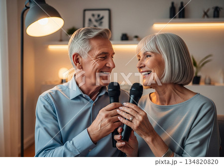 Elderly man and woman singing karaoke together in a cozy modern living room Elderly man and woman singing karaoke together in a cozy modern living room 134820820