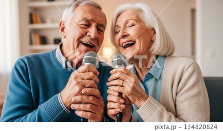 Elderly man and woman singing karaoke together in a cozy modern living room Elderly man and woman singing karaoke together in a cozy modern living room 134820824