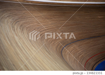 Sharp 42 degree turn on wooden track for cycling competitions. Sloping surface in turn at velodrome. Track surface for cycling. Cycling concept, background for track cycling competition 134821331