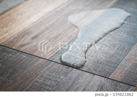 Laminate and water. Wooden floors are impervious to moisture. 134821862