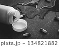 Tablets. Dropping pills and a glass of water from the hands. 134821882