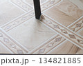 Ripped linoleum. Chair leg and torn linoleum. Hole in linoleum. 134821885