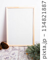 Wooden frame for a photo. Flower in a pot and a template for a photo.  134821887