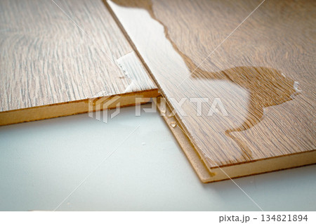 Laminate and water. Wooden floors are impervious to moisture. 134821894