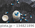 Tablets. Dropping pills and a glass of water from the hands. 134821896