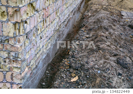 Preparing the building foundation for reinforcement by pouring concrete 134822449