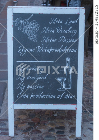 Chalkboard sign with wine list outside a local bar. Authentic street detail, European lifestyle, Italy 134822515