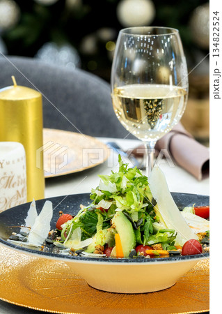 Green salad and wine served on table in restaurant Green salad and wine served on table in restaurant 134822524