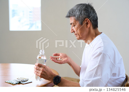 薬やサプリを飲むシニア男性 薬やサプリを飲むシニア男性 134825546