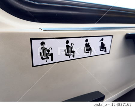 Sticker near seats for people with difficulty standing. Special seats at entrance to public transport for people who cannot stand. Seats for pregnant and elderly people on bus and train 134827165