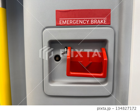 Emergency brake is red lever for stopping train. Pull switch down to stop train. Red handle is for stopping train in emergency. Emergency braking for public transport concept Emergency brake is red lever for stopping train. Pull switch down to stop train. Red handle is for stopping train in emergency. Emergency braking for public transport concept 134827172