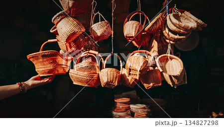Baskets hanging in a lively market environment. Baskets hanging in a lively market environment. 134827298