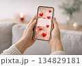 hands holding a smartphone with a romantic Valentine's Day message 134829181