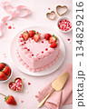Valentine's pink heart-shaped cake decorated with strawberries on pink background 134829216