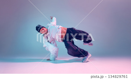 Breakdancer performing power move with dramatic lighting 134829761