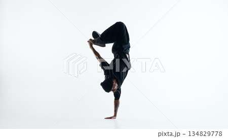 Breakdance inverted balance pose with one arm support isolated on white background Breakdance inverted balance pose with one arm support isolated on white background 134829778