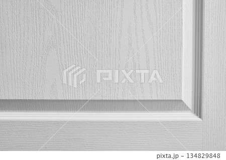 White textured wall with decorative molding, subtle relief pattern and soft natural shadow creating clean architectural background. Copy space 134829848