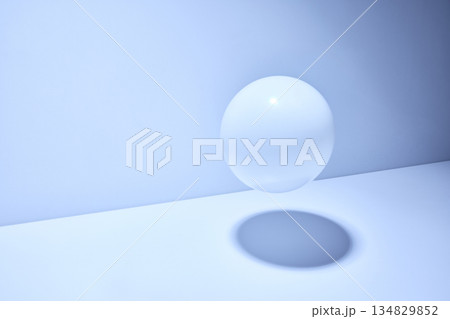 Minimal light blue studio interior with floating translucent glass sphere, soft shadow and clean modern composition with copy space Minimal light blue studio interior with floating translucent glass sphere, soft shadow and clean modern composition with copy space 134829852
