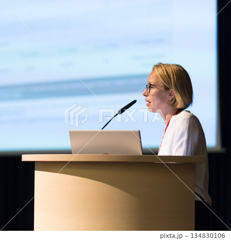 Female speaker giving a talk on corporate business conference. Business and Entrepreneurship event Female speaker giving a talk on corporate business conference. Business and Entrepreneurship event 134830106