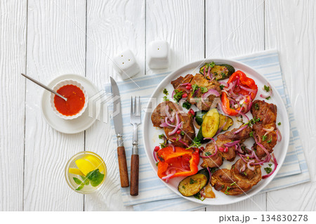 Grilled pork neck chunks with roasted veggies 134830278