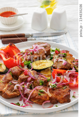 Grilled pork neck chunks with roasted veggies 134830286