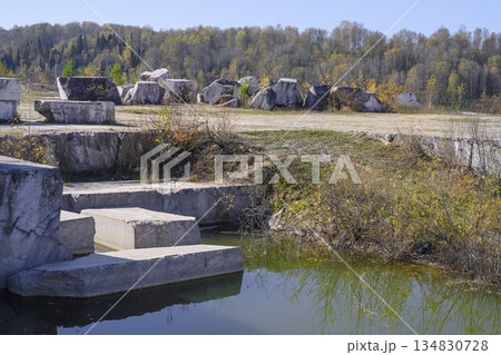 Huge cubic and geometric stone shapes in an abandoned Peteni marble quarry in Siberia Huge cubic and geometric stone shapes in an abandoned Peteni marble quarry in Siberia 134830728
