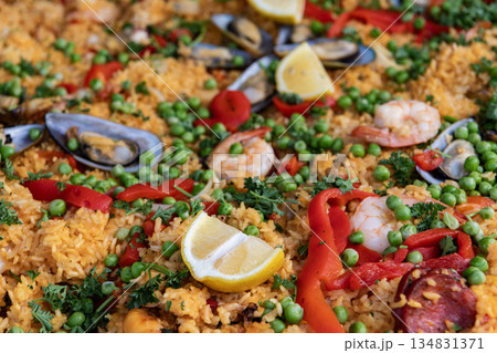 Traditional rice seafood paella. Dish of Spain, seafood paella background. Spanish paella with shrimps, culinary recipe. Rice food dish. Rice risotto. Paella seafood. Spanish cuisine. Food court 134831371